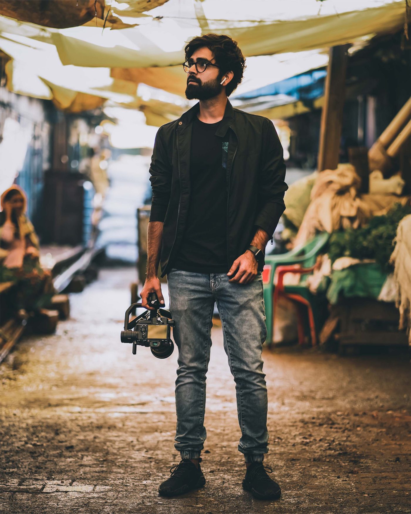 Nishit Sharma holding a gimbal in a market lane